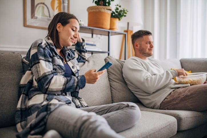 bored couple sitting on couch