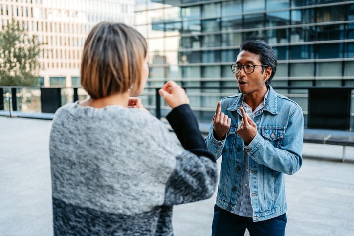 couple arguing in front of office building