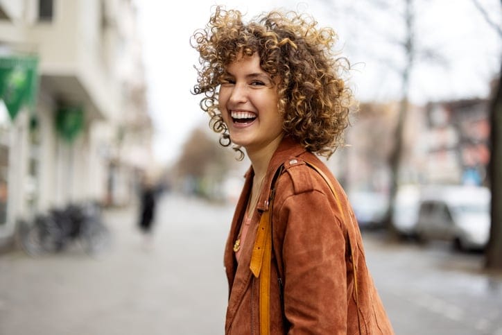 Beautiful woman smiling on street.