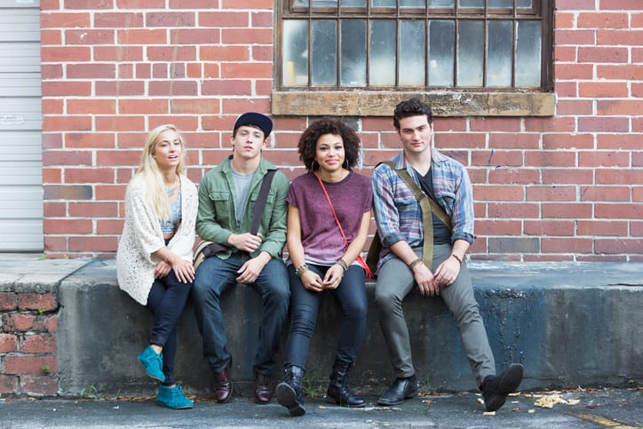 Group of young adults (18-20 years) hanging out in city.