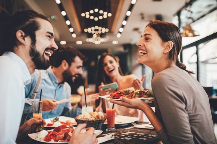 Group of friends having breakfast in a restaurant.