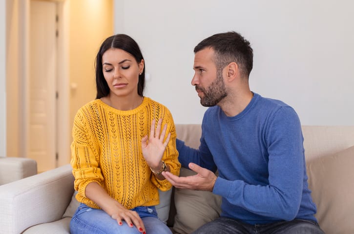 Stressed young man saying sorry after a quarrel with wife.