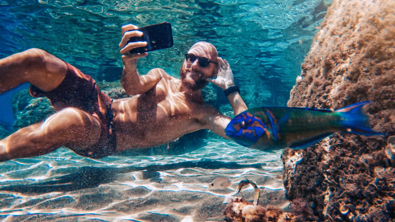 Man taking an underwater selfie.