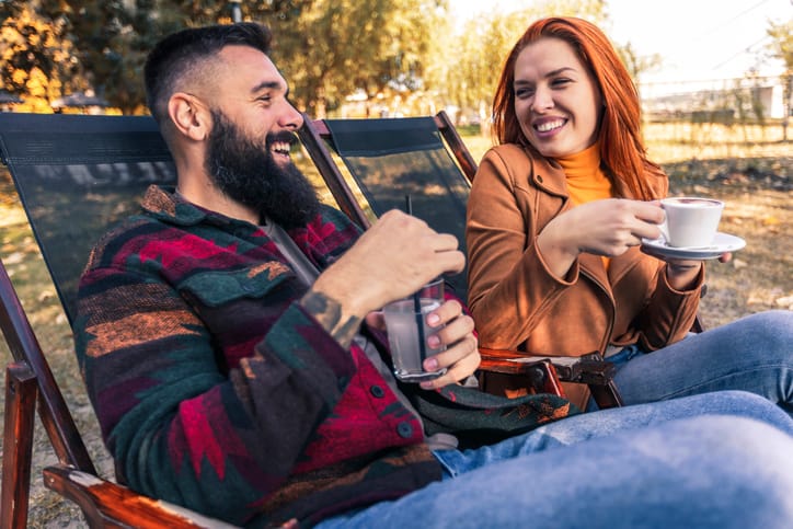 Beautiful loving couple sitting in a cafe enjoying in coffee and conversation.