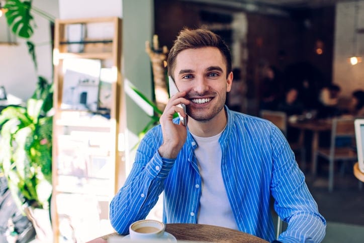 smiling guy talking on phone