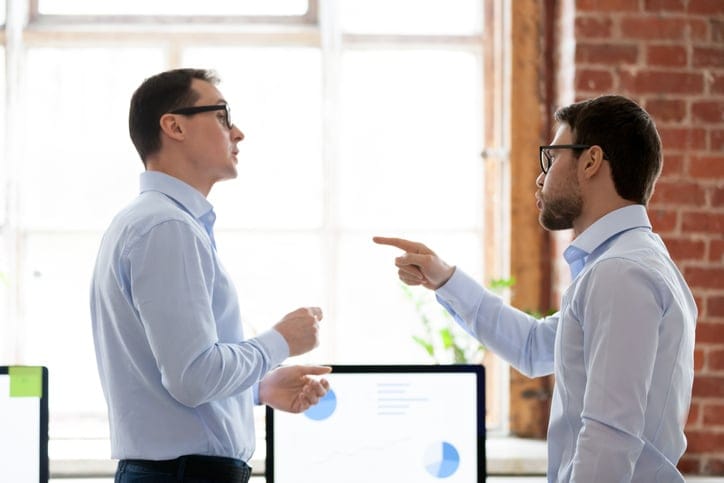 Two male colleagues arguing.