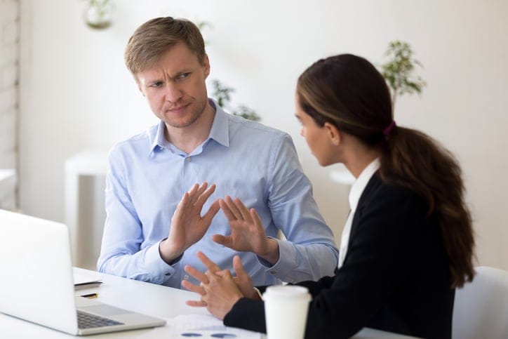 Young businessman rejecting giving interview to journalist
