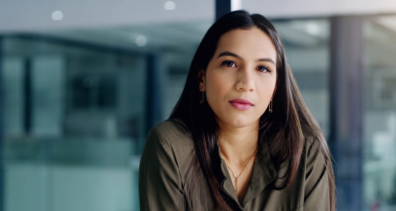 Serious woman sitting in office.