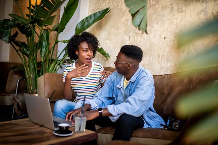 Young people having a chat at the bar.