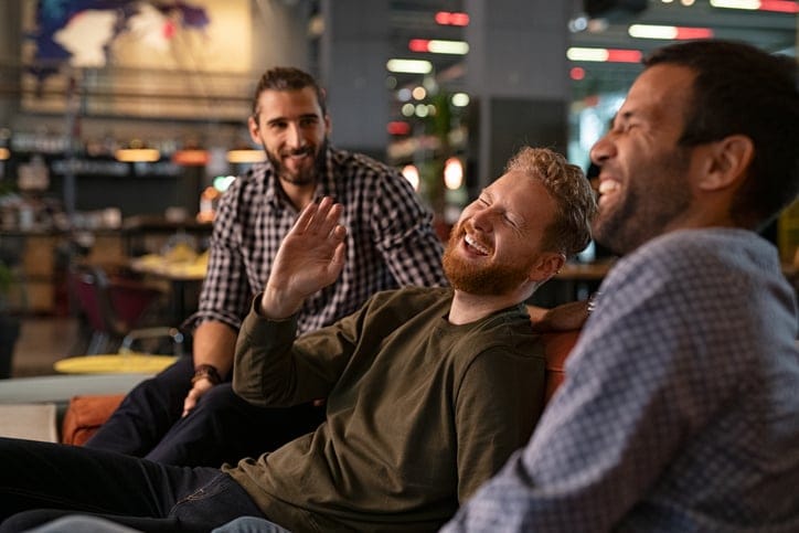 Male friends hanging out laughing.