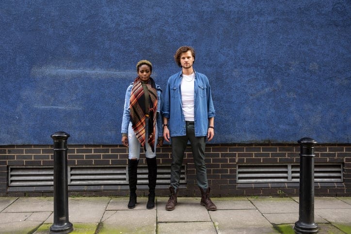 Lovely couple portrait against a deep blue wall