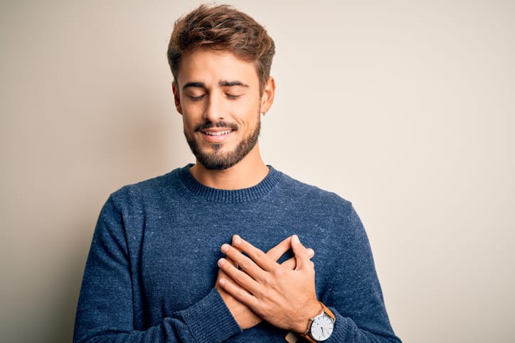 Man with his hand on his heart.