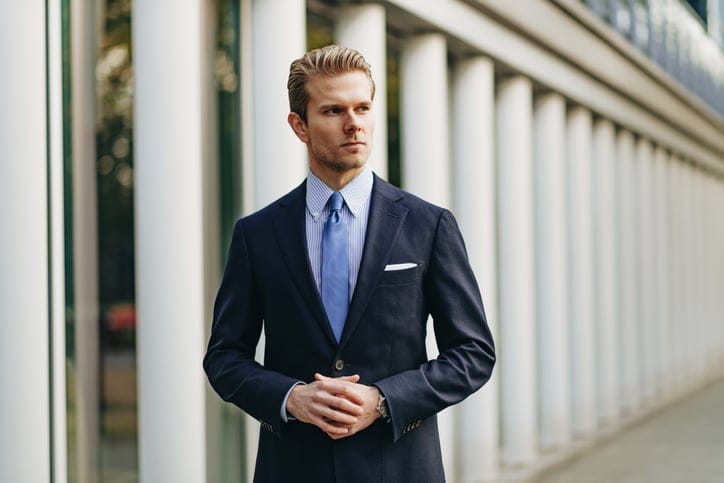 debonair man in business suit walking outside