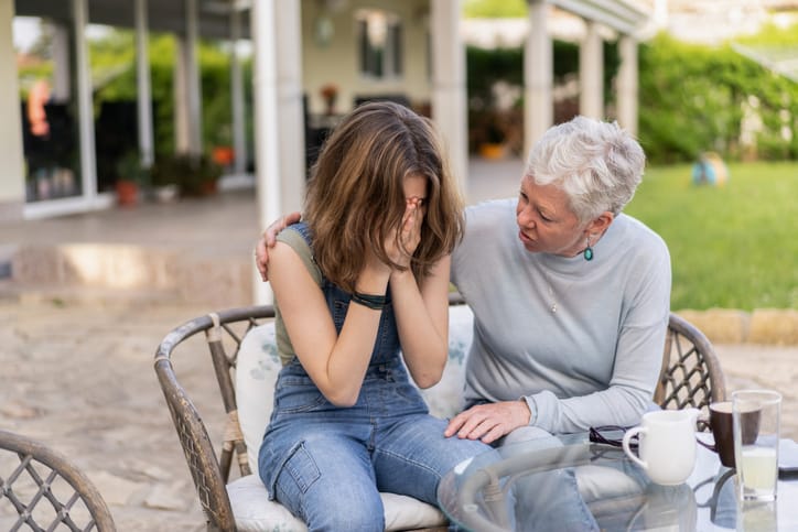 grandmother comforting granddaughter