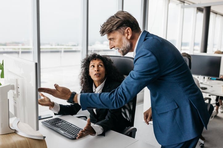 Angry male boss talking to female worker.