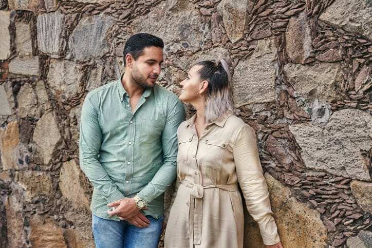 Young latin male and female couple looking at each other in love between 25 and 35 years old