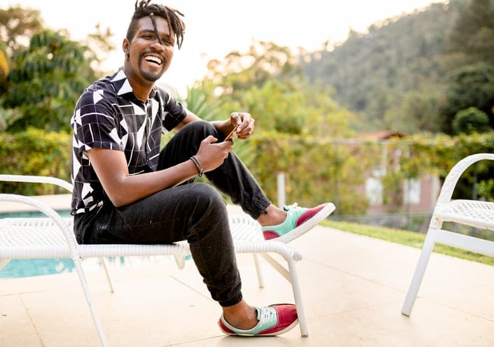 smiling guy sitting outdoors in summer