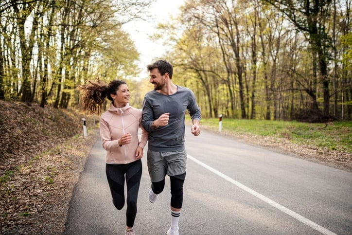 Happy athletic couple running.