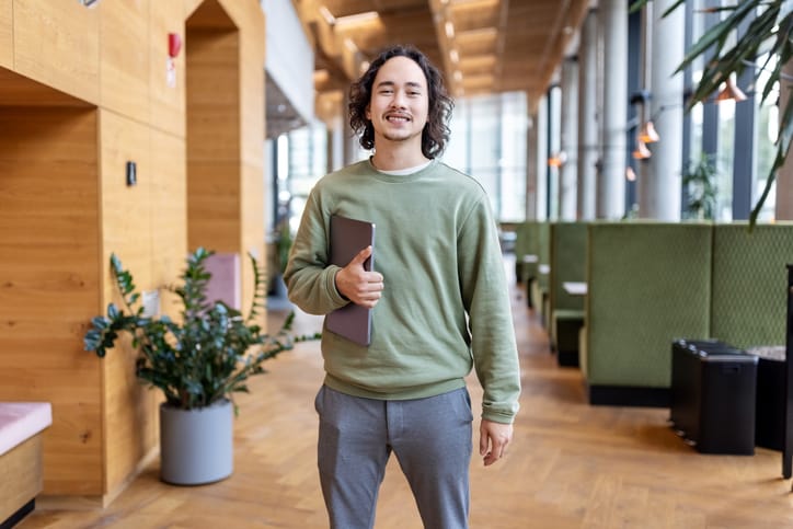 smiling business casual man holding folder