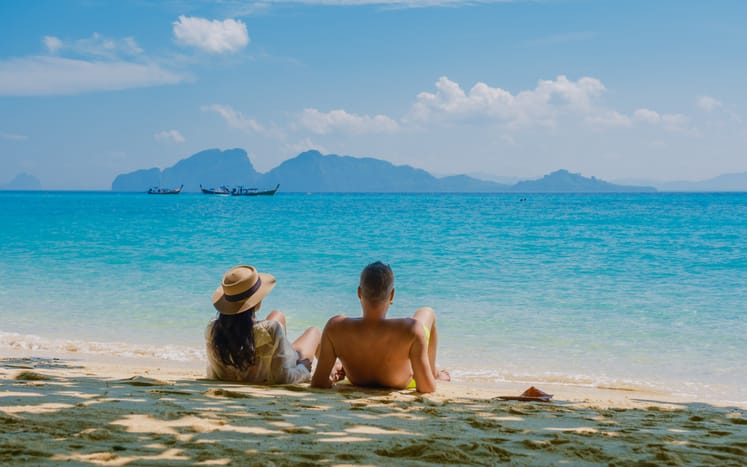A couple sitting at the beach.