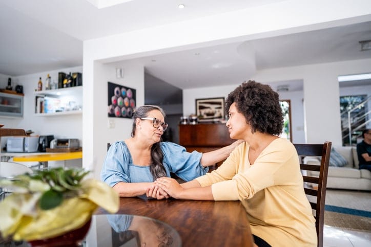 Senior mother consoling her daughter at home
