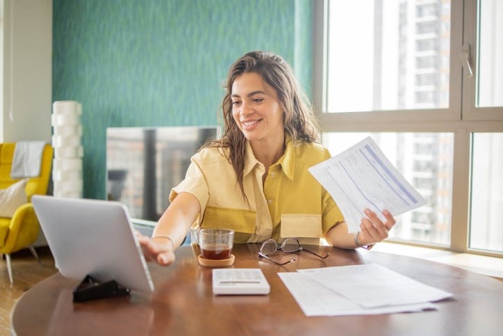 Young woman going through paperwork.