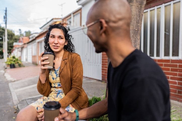 male and female friend having coffee outside