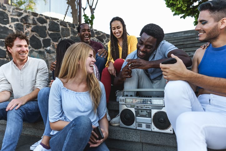 Young friends having fun listening music.