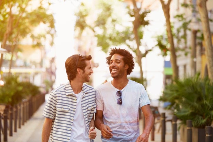 Male friends walking outdoors.