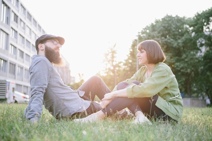 male and female friend talking in park