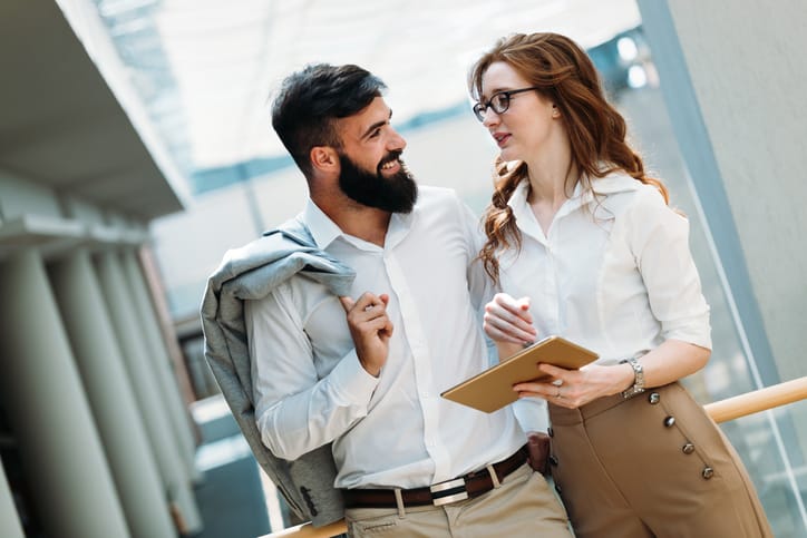 Picture of handsome businessman and beautiful businesswoman in company