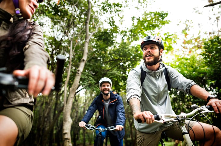 Guys hanging out on bike ride.