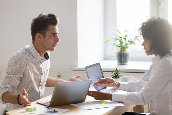 Multiracial colleagues argue about document disagree having conflict at work, diverse coworkers disputing about mistake in paperwork, african businesswoman blaming caucasian partner of bad contract