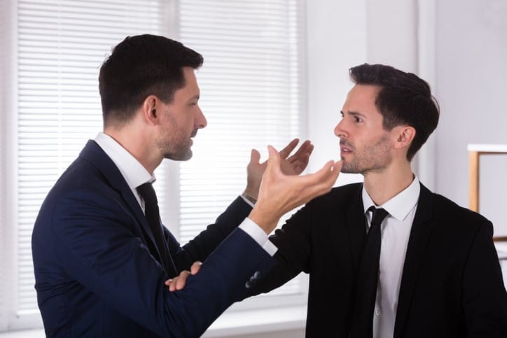 Angry Businessman Holding His Partner's Tie.