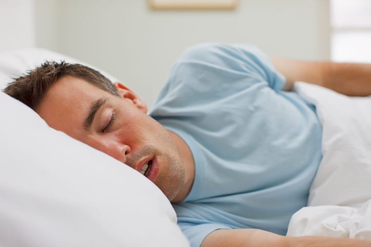 Man sleeping in bed.