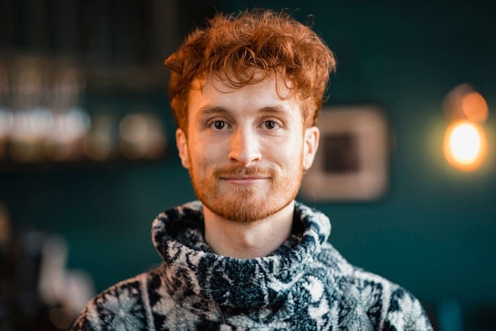 young readhead guy smiling at camera