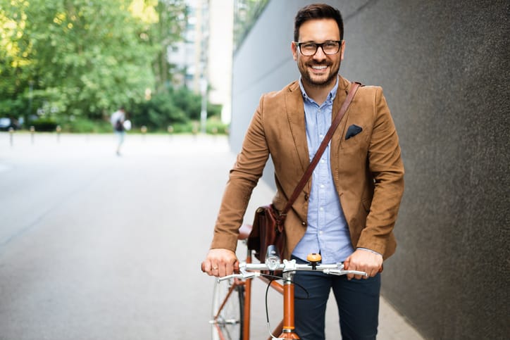 Young businessman going to work by bike.
