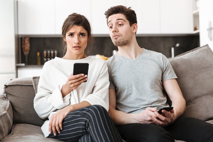 Young woman holding mobile phone.