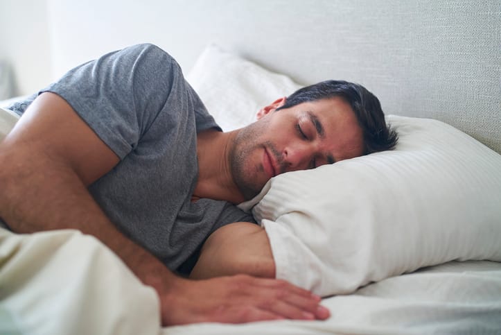 Man sleeping in bed.