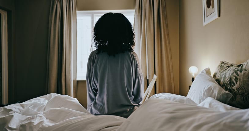 Woman getting out of bed in the morning.