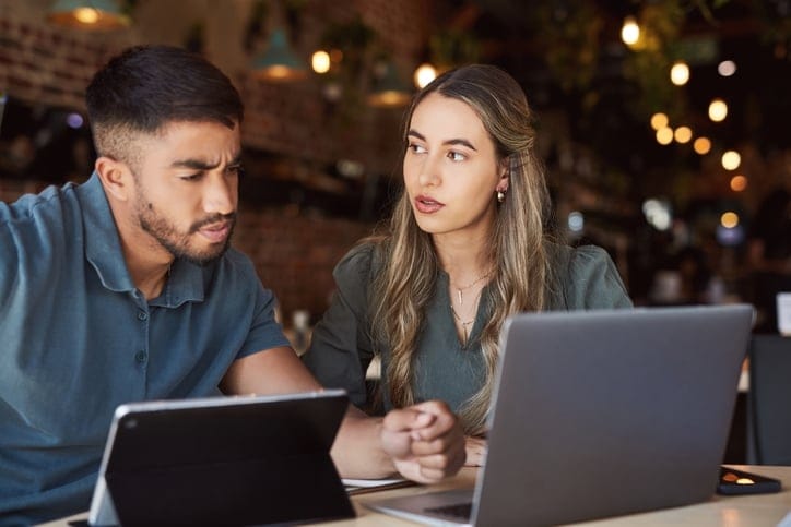 Man and woman collaborating on work.