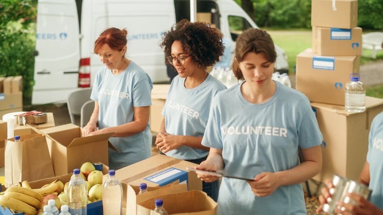 Group of volunteers preparing free food.