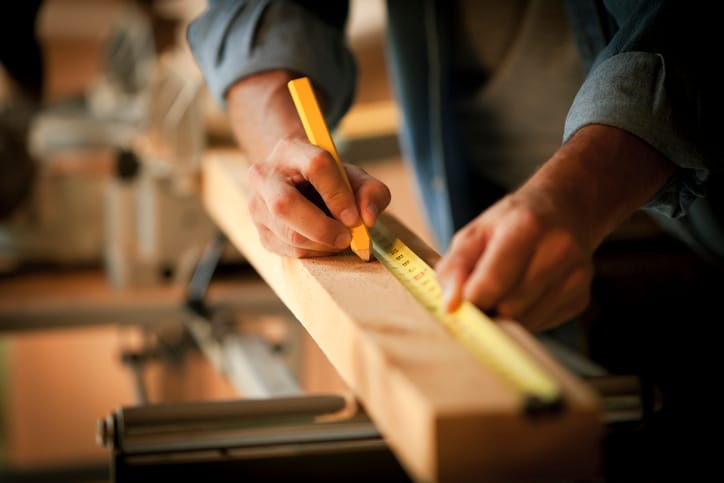 guy measuring wood