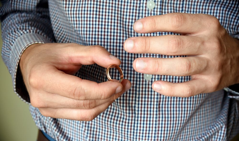 Man removing his wedding ring.