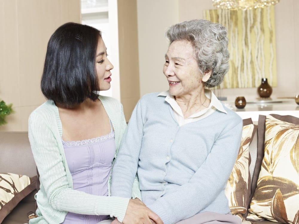 Mother and daughter smiling at one another.