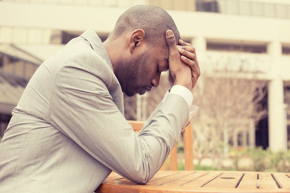 Businessman stressed over work.