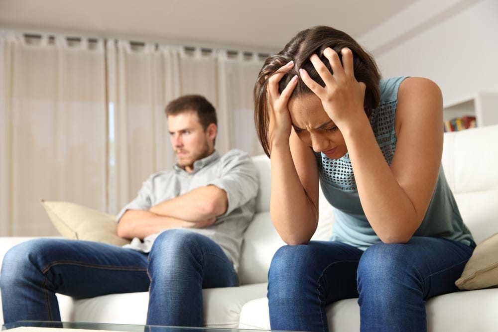 Woman angry with her head in her hands.