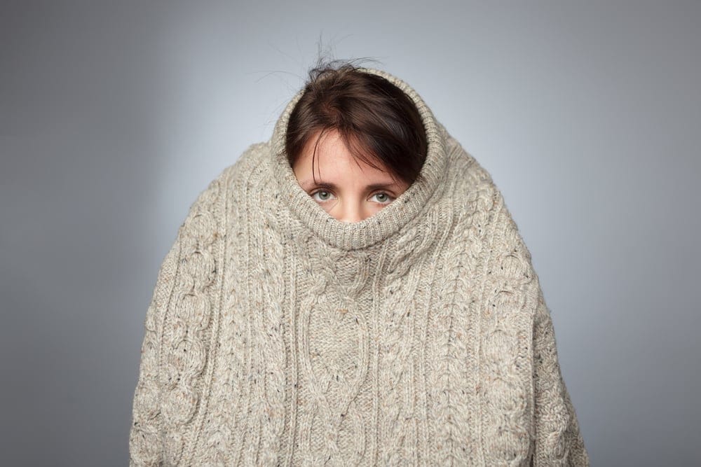 Woman hiding in a large sweater.