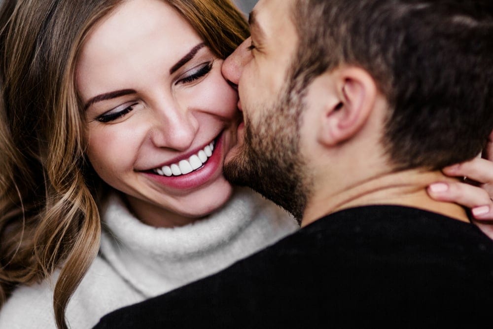 Couple kissing one another.