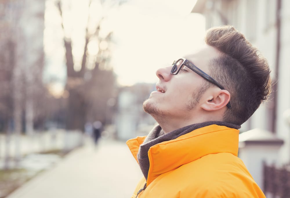 Man breathing in deeply in peace.